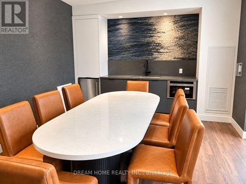 A conference room with a large table and chairs.