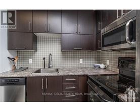 A kitchen with brown cabinets and a black stove top oven.