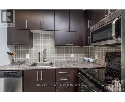 A kitchen with brown cabinets and a black stove top oven.