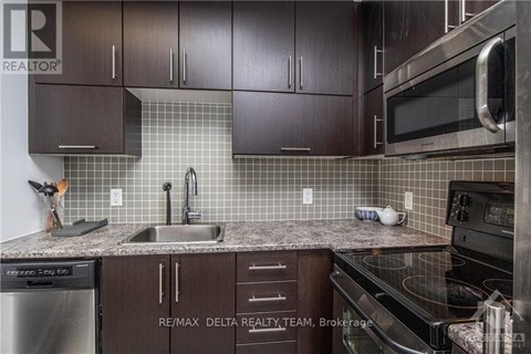 A kitchen with brown cabinets and a black stove top oven.