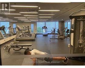A man is working out in a gym with a variety of equipment.