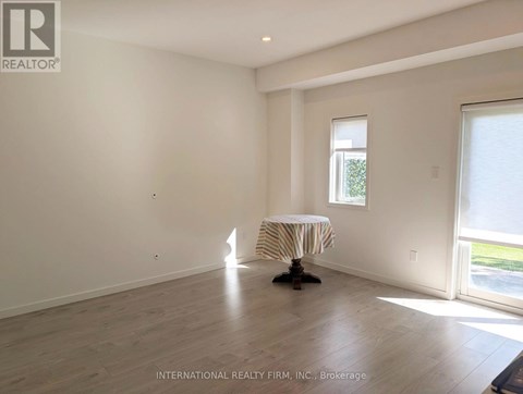 A room with a round table and a window.