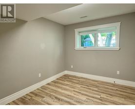 A room with a window and wooden flooring.
