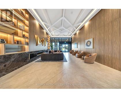A modern lobby with a marble floor and wooden walls.