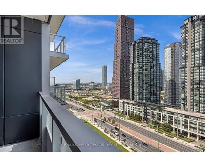 A cityscape with tall buildings and a clear sky.