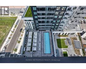 A modern building with a pool in the middle of the courtyard.