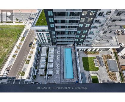 A modern building with a pool in the middle of the courtyard.