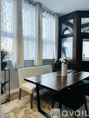 A dining room with a wooden table and chairs.
