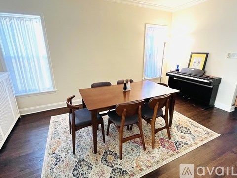 A dining room with a wooden table and chairs.