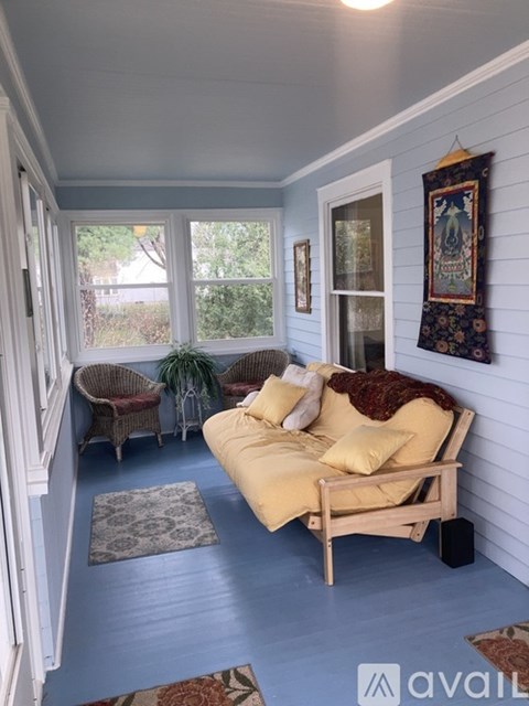 A living room with a couch and a chair.
