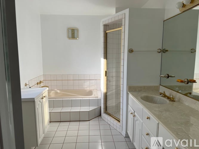 A bathroom with a white tub and sink.