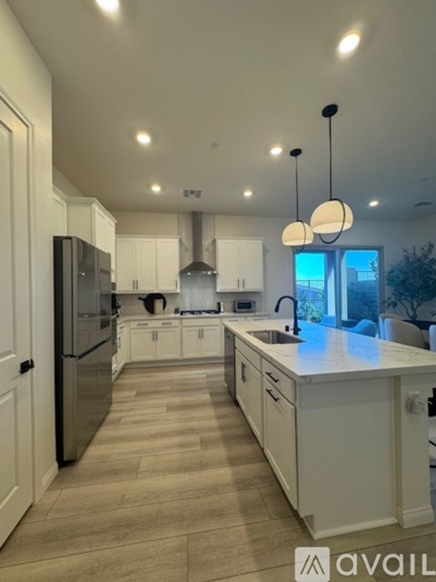 A modern kitchen with white cabinets and a large island.