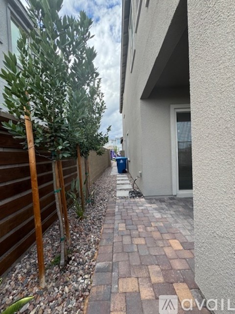 A narrow alley with a wooden fence on the left and a building on the right.
