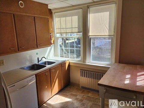 A kitchen with wooden cabinets and a washing machine.