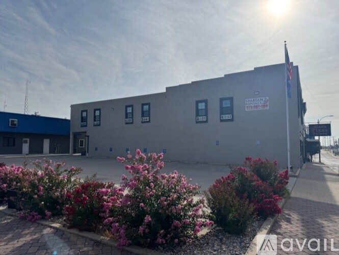 A building with a sign that says "AVAILABLE" in front of it.