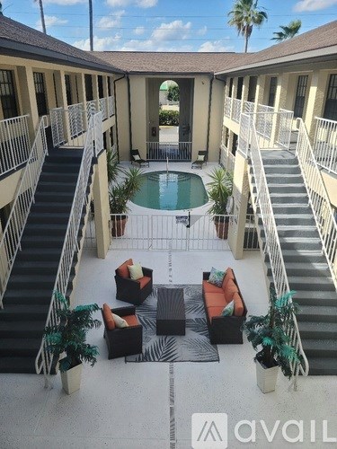 A patio with a pool and a staircase.