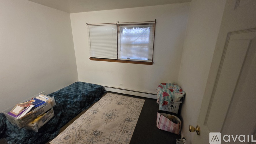A room with a bed, a window, and a door.