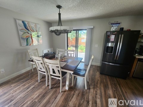 A dining room with a table and chairs.
