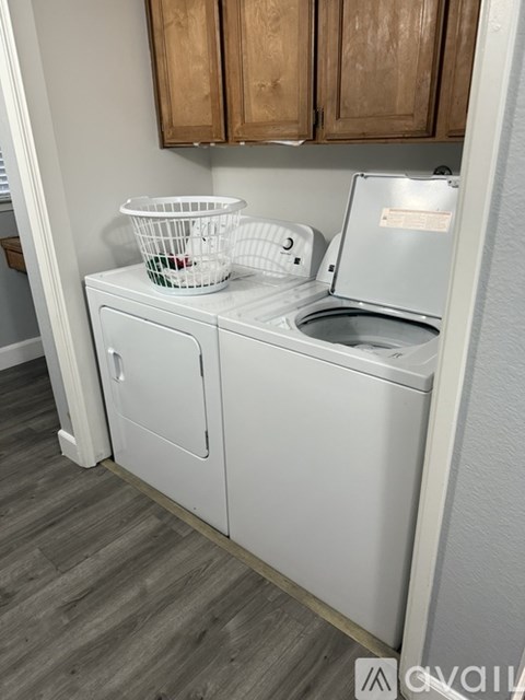 A white dishwasher with a basket on top of it.