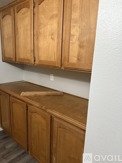 A kitchen with wooden cabinets and a countertop.