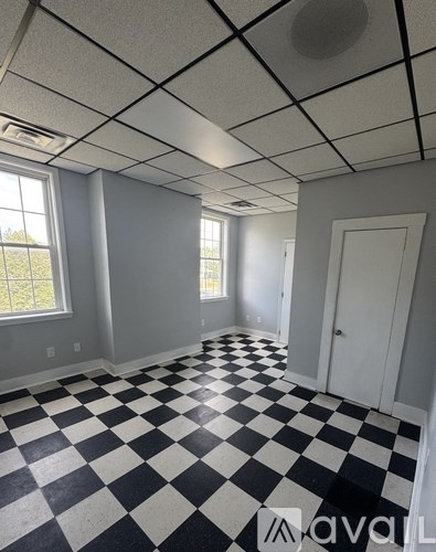 A room with black and white checkered flooring and white walls.