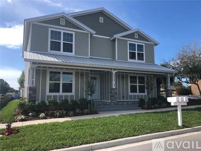 A house with a grey roof and white trim is for sale.