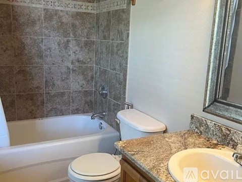 A bathroom with a toilet, sink, and bathtub.