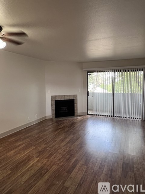 A room with a fireplace and wooden floors.