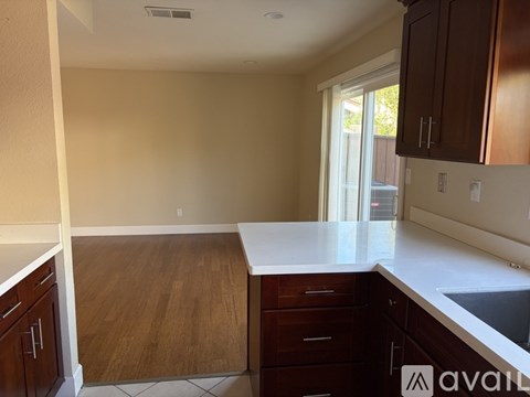 A kitchen with wooden cabinets and a white countertop.