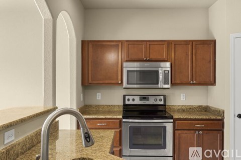 A kitchen with a stove top oven and microwave above it.