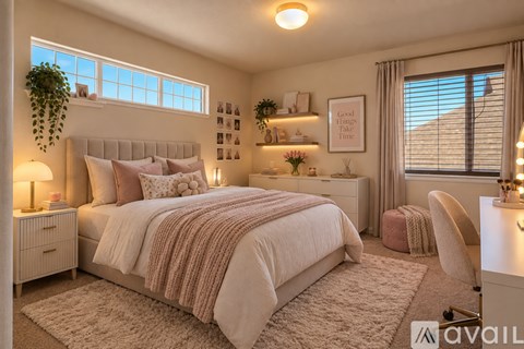 A well-lit bedroom with a large bed and a desk.