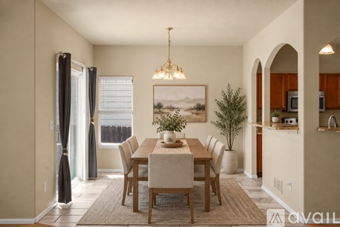 A dining room with a wooden table and chairs.