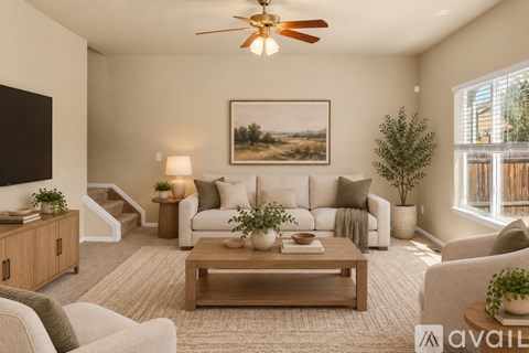 A living room with a white couch, a wooden coffee table, and a painting on the wall.