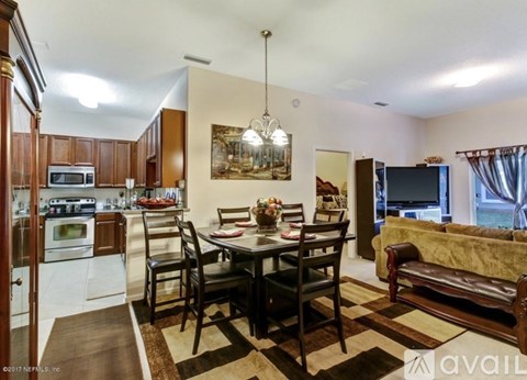 A well-lit kitchen with a dining table set for four.