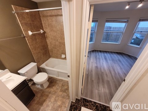 A bathroom with a toilet, sink, and bathtub.