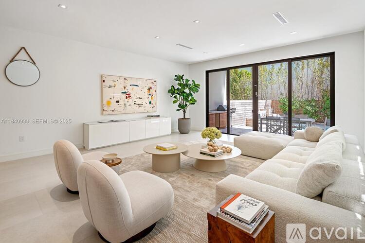 A living room with a large sofa, armchairs, and a coffee table.