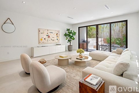 A living room with a large sofa, armchairs, and a coffee table.