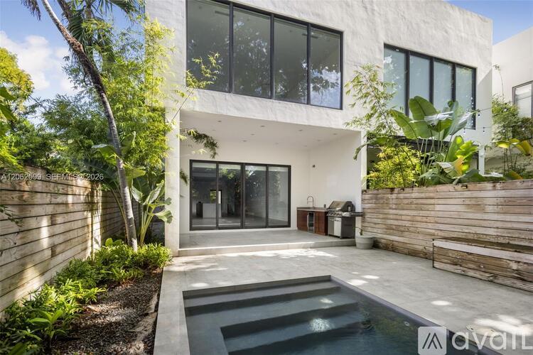 A modern house with a pool in the backyard.