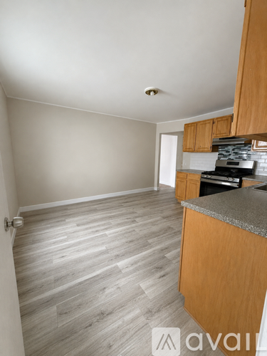 A kitchen with wooden cabinets and a countertop.