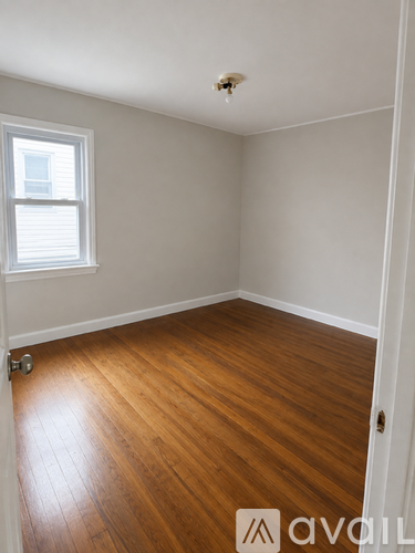 A room with wooden floors and a window.