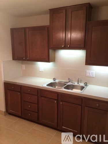 A kitchen with brown cabinets and a white countertop.