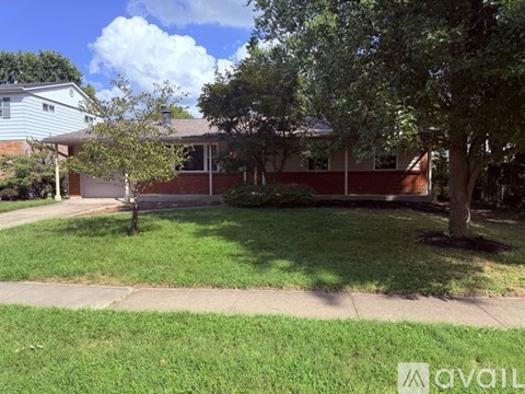 A house with a tree in front of it.