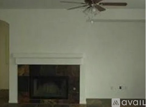 A fireplace with a fan above it.