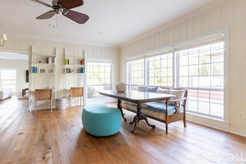 A spacious room with a blue exercise ball and a wooden floor.