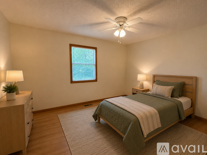 A bedroom with a bed, nightstands, and a window.