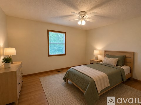 A bedroom with a bed, nightstands, and a window.