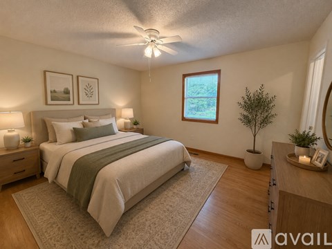 A bedroom with a large bed and a window.