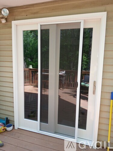 A white sliding door with a glass panel is open.