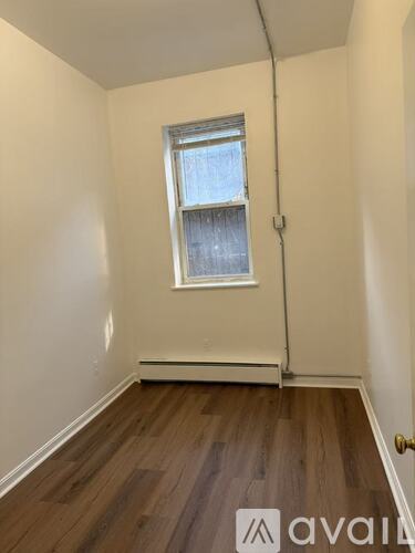 A room with wooden floors and a window.