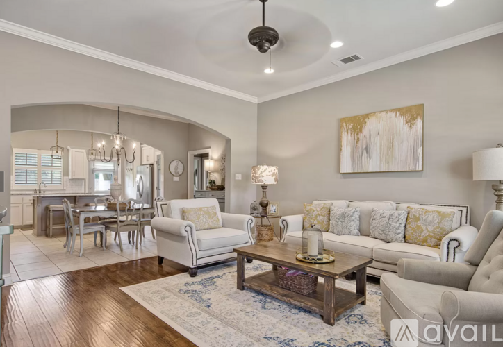 A living room with a white couch and a wooden coffee table.